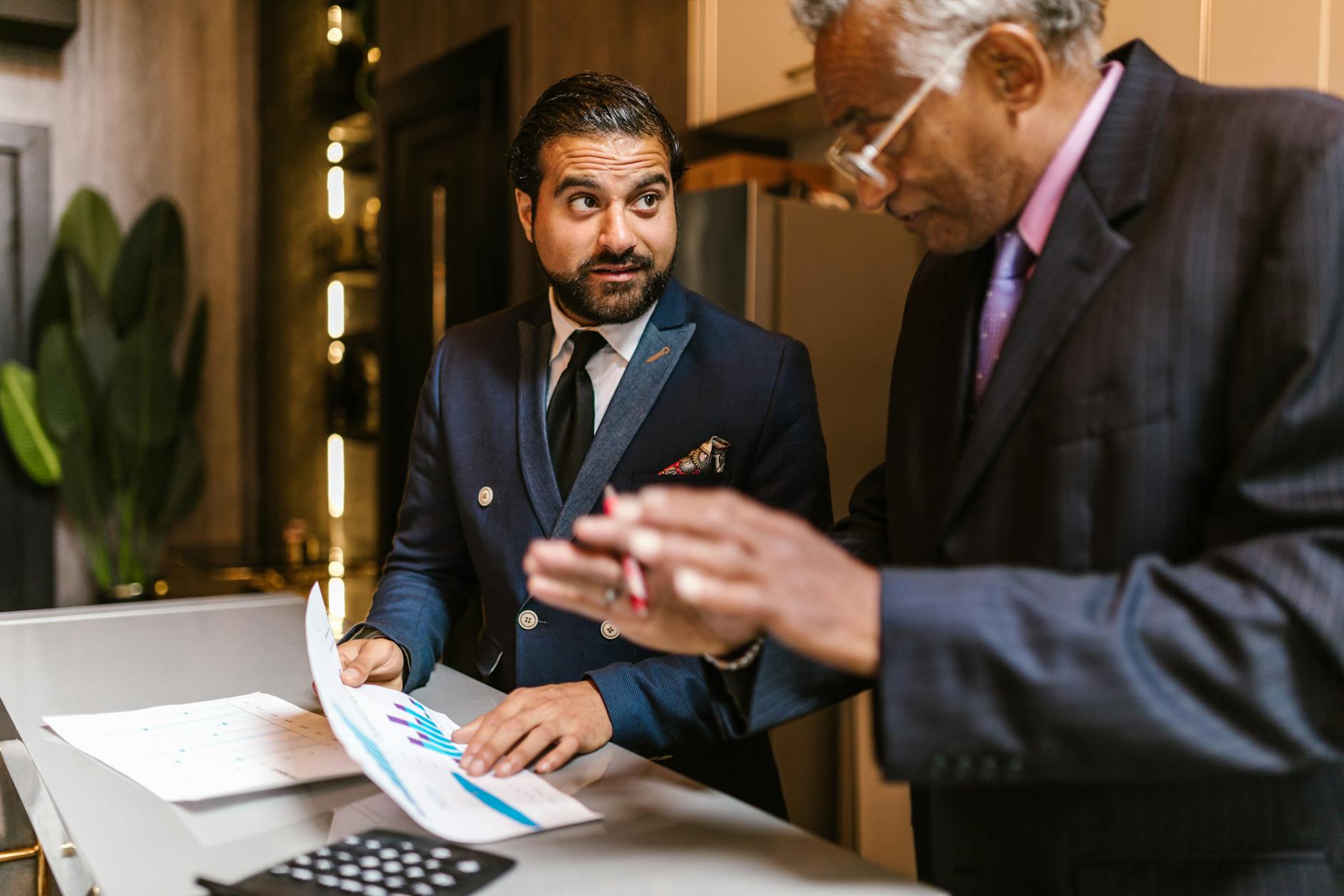 A small NYC business owner reviews mid-year finances at a counter, applying an NYC business strategy to manage rising costs.