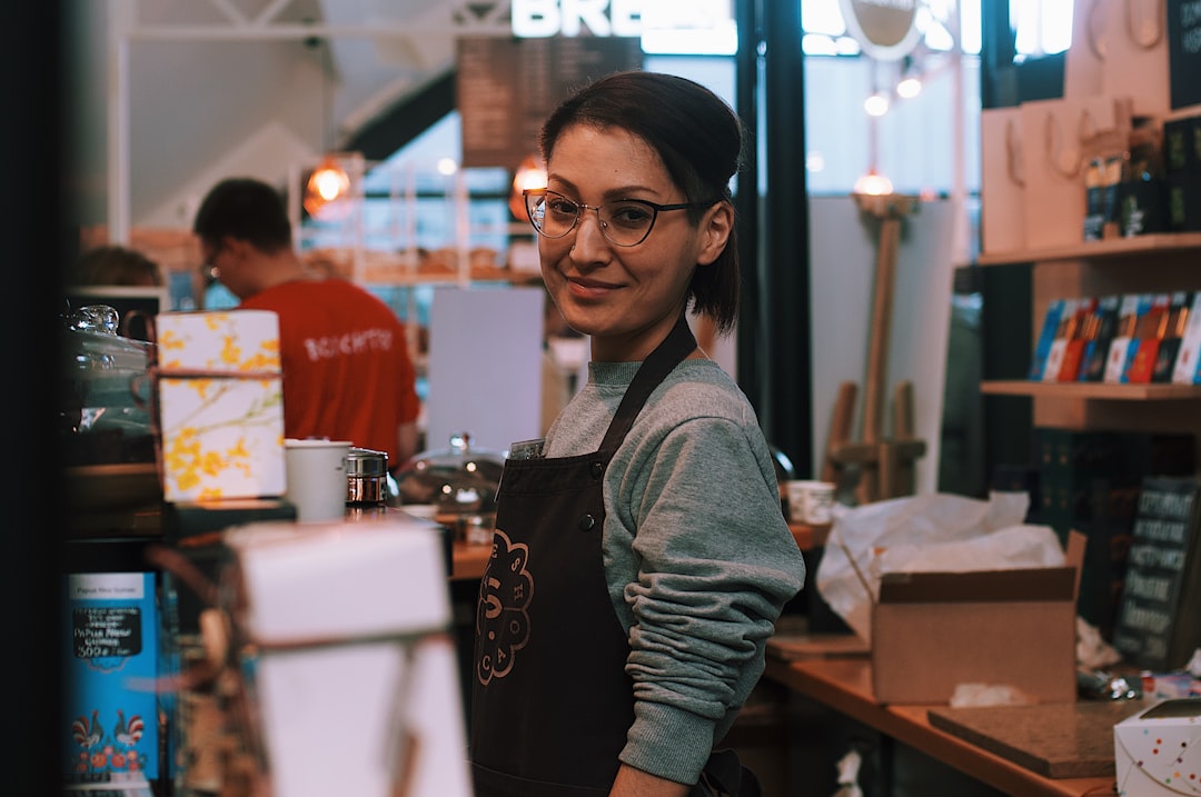 A woman business owner serves a customer inside her immigrant-owned shop in New York City
