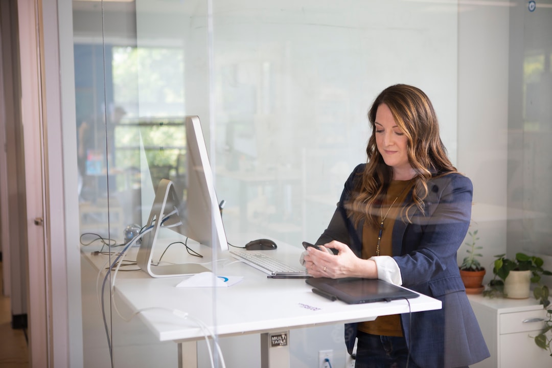A woman entrepreneur reviews small business license documents at her New York City office desk