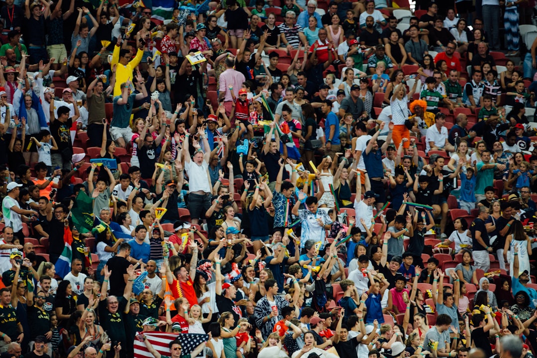 Excited soccer fans cheering together at a New York City bar during a World Cup match screening