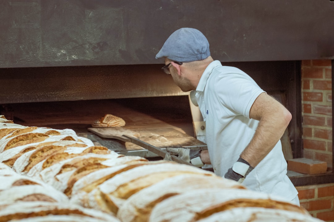 A baker hands a gluten-free loaf to a customer inside a Manhattan bakery, showing the growing demand for gluten-free.