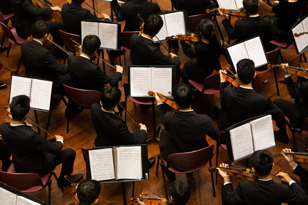 A conductor leads the Festival Orchestra of Lincoln Center in a Mostly Mozart concert at David Geffen Hall