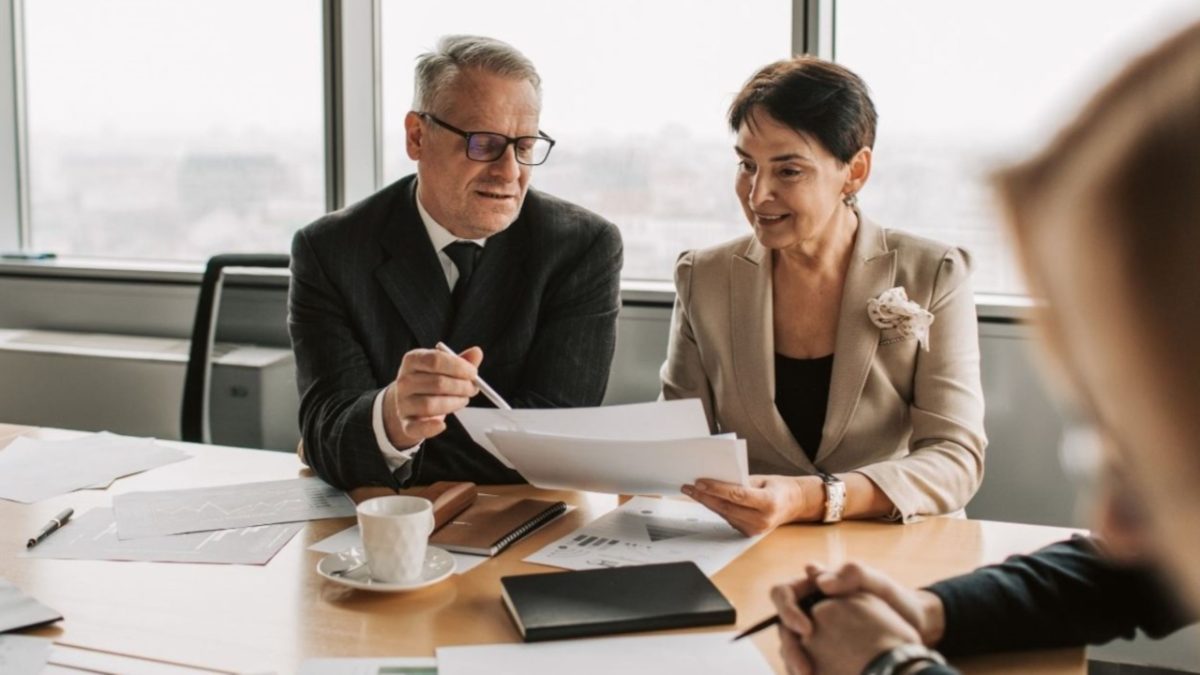 A financial advisor discusses the pied-à-terre tax with a client in a Manhattan luxury apartment