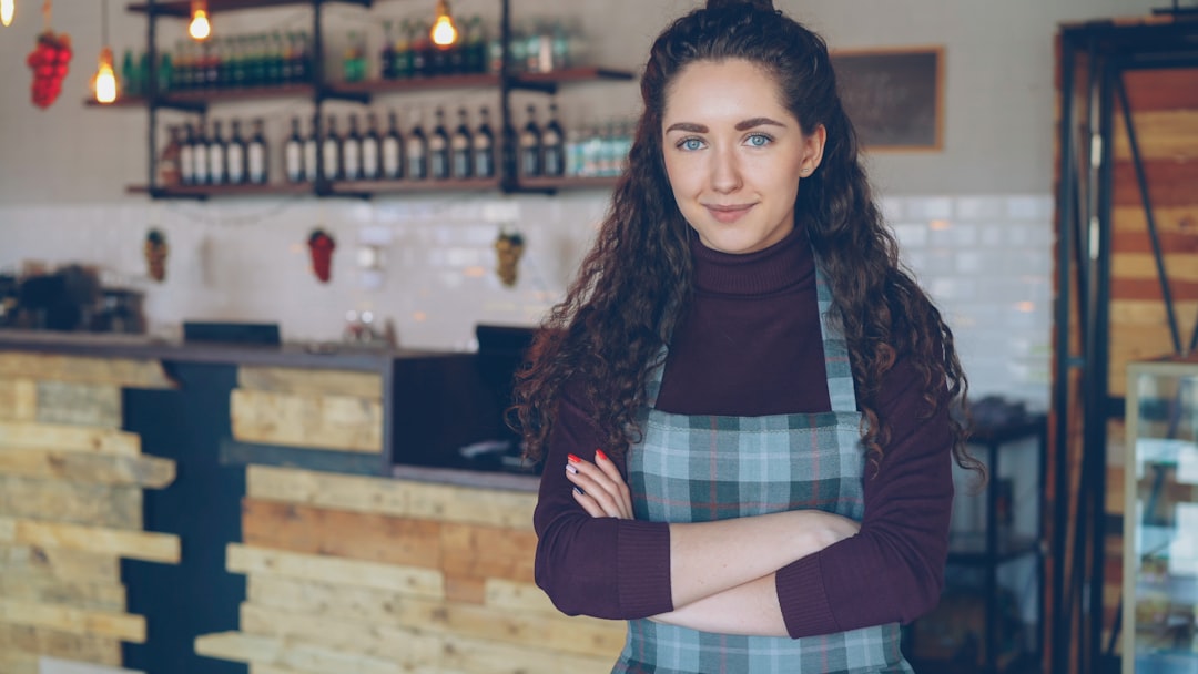 A small business owner stands in front of her New York City shop, reviewing everything to keep her small business thriving.