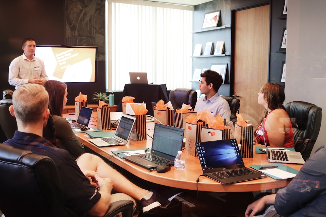A startup founder presenting to her first investor in a New York City office, with a pitch deck visible on screen