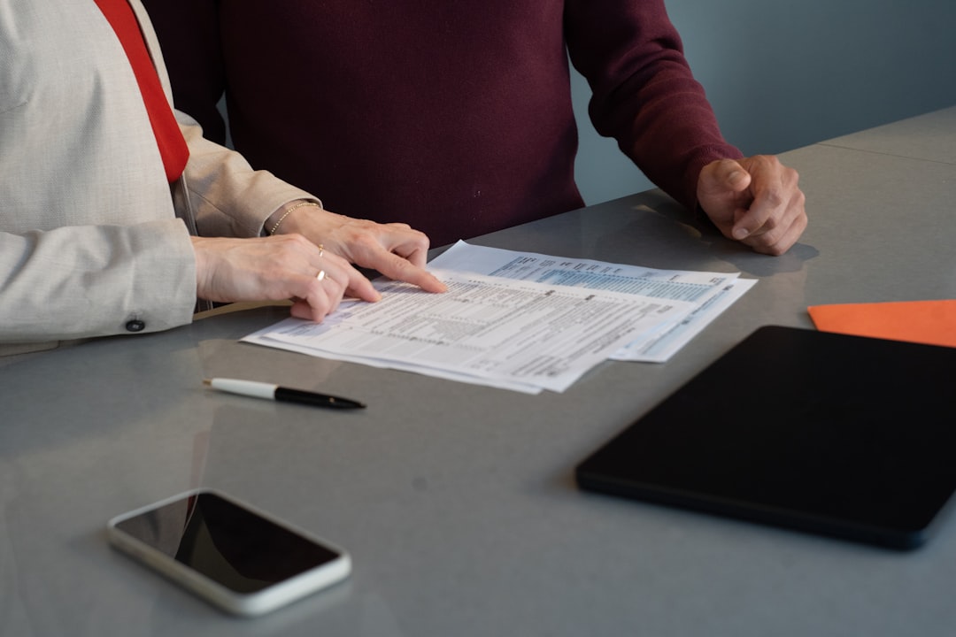 A small business owner reviews an employment contract before bringing on their first employee in New York City