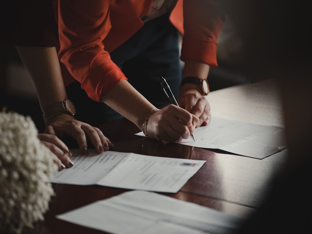 A focused entrepreneur completes paperwork to register a sole proprietorship at a city office desk in New York