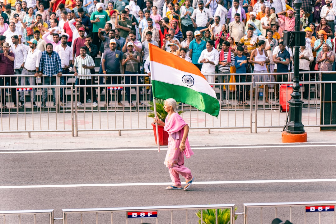 A woman in traditional dress waves the Indian flag during the India Day parade on Madison Avenue in New York City