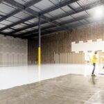 A small investor reviews documents inside a New York City storage units facility, assessing occupancy and returns data.