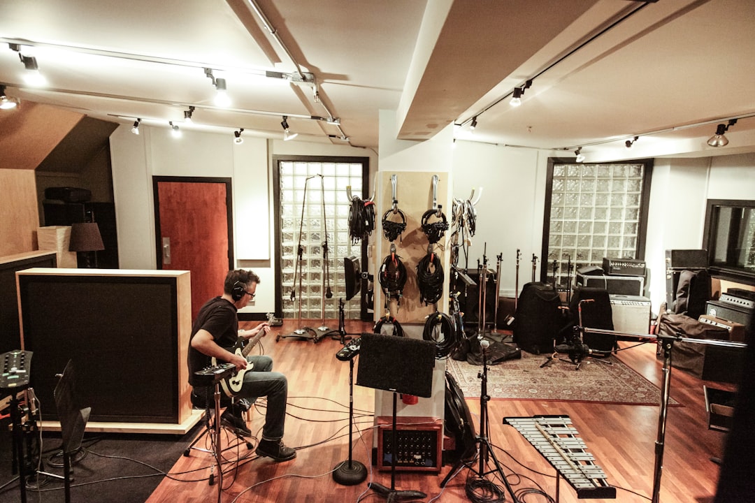 An independent artist recording vocals in an affordable studio space in New York City