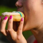 Visitor buying fresh cider doughnuts at a Hudson Valley orchard stand