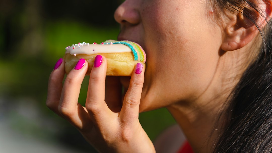 Visitor buying fresh cider doughnuts at a Hudson Valley orchard stand